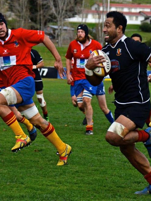 Old Boys flanker Maene Mapusaga runs away from Kurow defenders (from left): Hamish Thompson,...