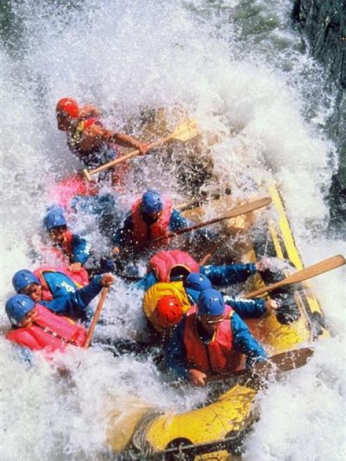 The Original White Water Rafting Company taking a group of rafters through the Mother-in-Law...