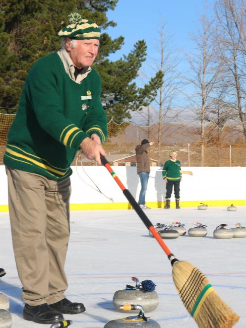 Charles Hughes, of Lowburn Curling Club, directs where he wants the stone at the Alexandra...