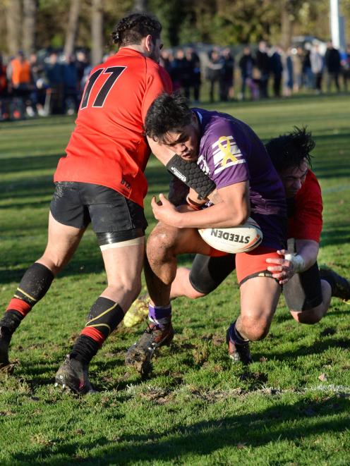 Steven Campbell-Paniona, of the South Pacific Raiders, is caught in the tackle of Dunedin Bears...