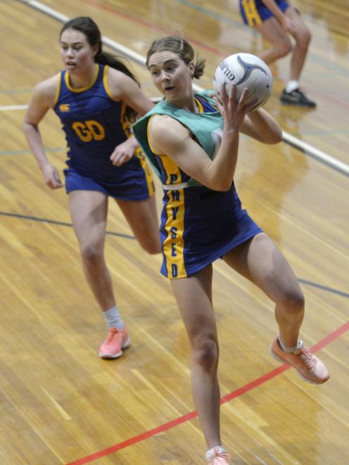 Phys Ed A's Laura Moffatt takes a pass in front of Phys Ed B's Meg Timu during their premier club...