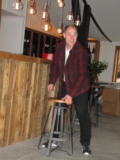 Canyon Restaurant owner Hayden Johnston sets out bar stools before welcoming his first guests. Photo: Mark Price