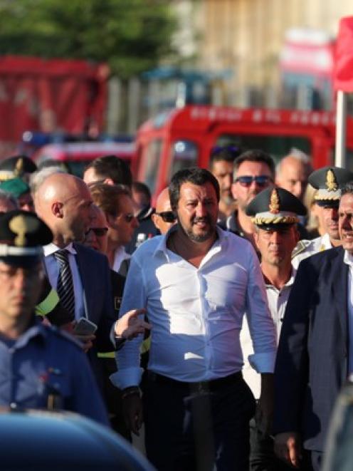 Italian Interior Minister Matteo Salvini leaves the site of the collapsed Morandi Bridge. Photo: Reuters