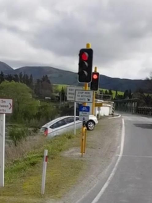 The moment a vehicle rolled down a bank after reversing out of the one-lane bridge at Beaumont on...