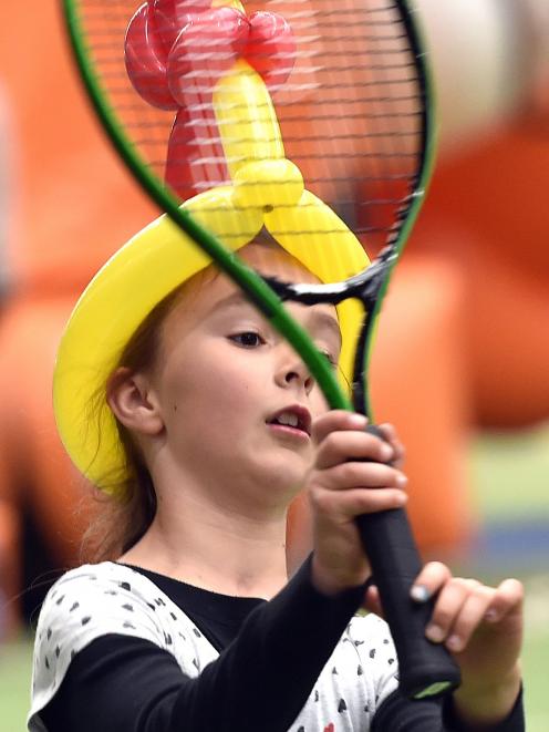 A determined Olivia Harwood keeps her eyes set on a pair of airborne tennis balls during the...