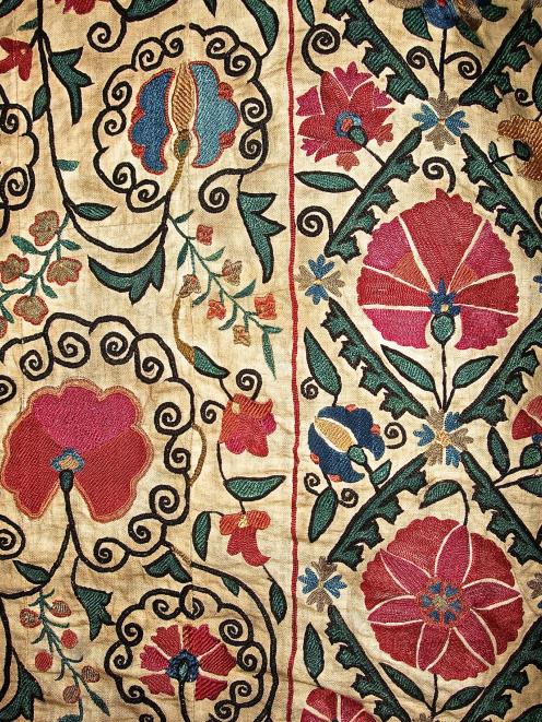 Detail of the embroidery, which depicts stylised regional flora. 