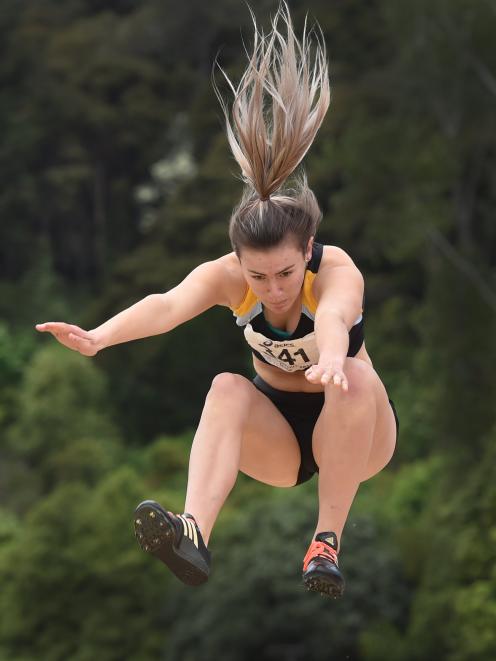 Sophie Miller (16) competes in the long jump during Saturday's track and field meeting at the...