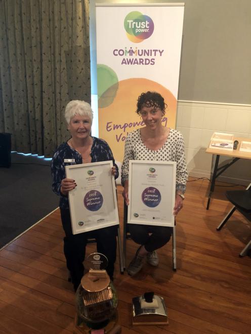 Shirley Dunick (left), of the St John Central Otago Shuttle, and Jeannie Galavazi, of the Wakatipu Wildlife Trust, display the certificates and trophies presented to them at the Trustpower Community Awards at the Alexandra Memorial Hall last night. Photo: