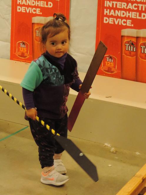 Kaya Henare (2), from Ohai, was eager to help out after watching her mother, Amber Poihipi,...