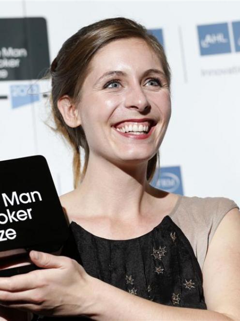 Eleanor Catton holds up the Man Booker Prize she received for her novel The Luminaries last year....