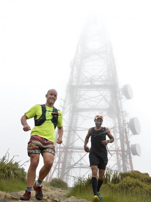 Emerging from the fog as they descend Mt Cargill are Phil Petersen (left) and Harjinder Chandra.