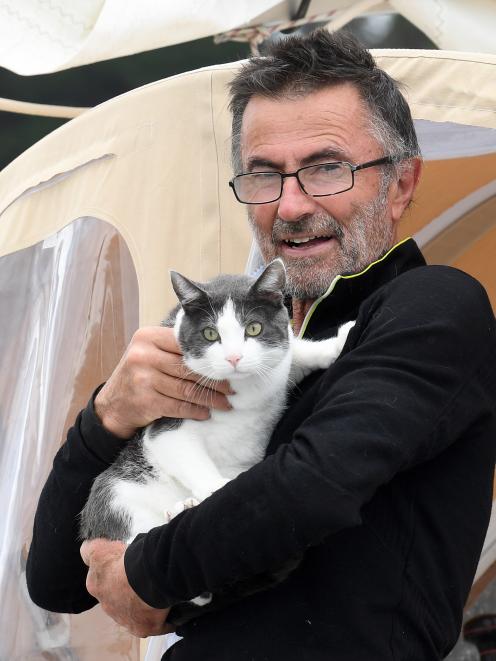 French solo round-the-world yachtsman Francis Tolan holds feline crew Navy.