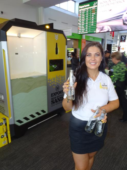 DB promotions staff member Dakota Johnston with the DB Export beer bottle sand machine at...