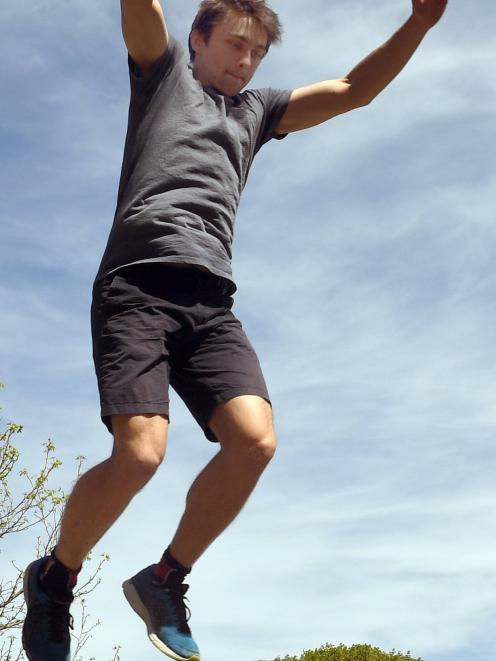 Reporter Jono Edwards bounds from the top of a wall.