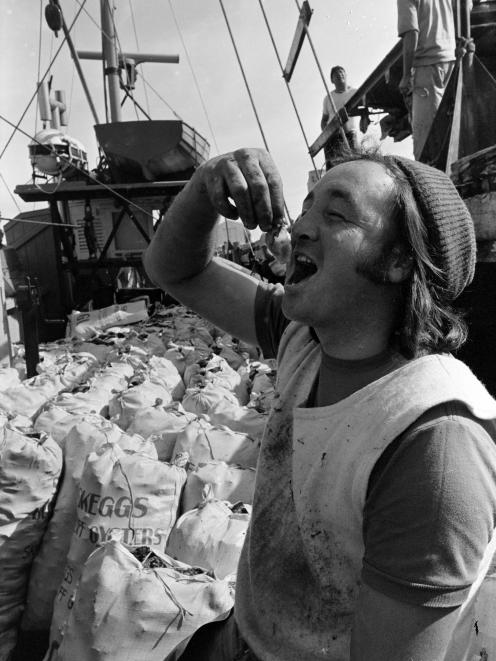 Terry Osborne, of Bluff, samples the delicacy as the first boat unloaded at the port at the start...