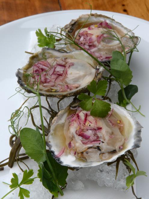 Fresh Bluff oysters with chardonnay shallot vinaigrette prepared by Vault 21 executive chef Greg...