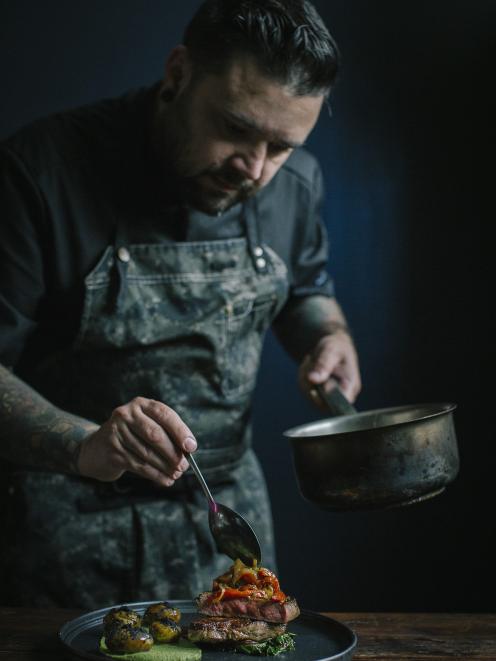 Pablo Tacchini puts the finishing touches on his winning dish — 55-day aged rib eye, broccoli and lemon purée, charcoal potatoes, smoked sour cream and smoked red pepper sofrito.