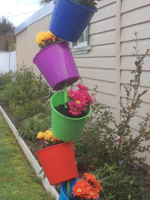 Stacked buckets in a Dunedin Garden.