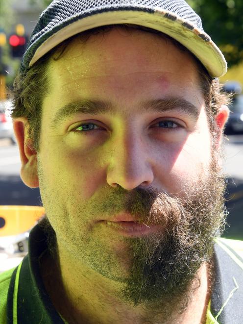Hayward College contractor Todd Hendry poses halfway through a beard trim.