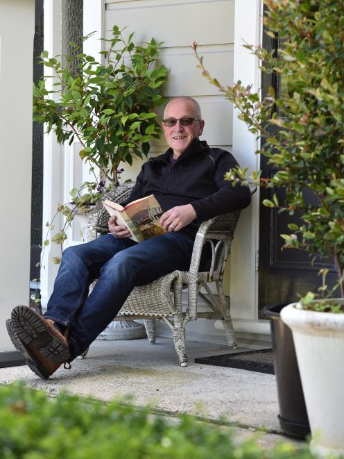 Co-owner Rex Johnston relaxes on the front veranda. 