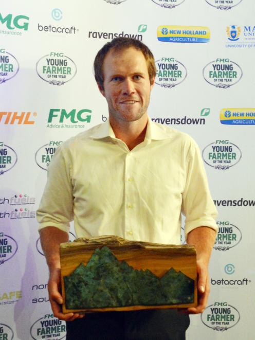 Alan Harvey displays the trophy he received for winning Aorangi FMG Young Farmer of the Year....
