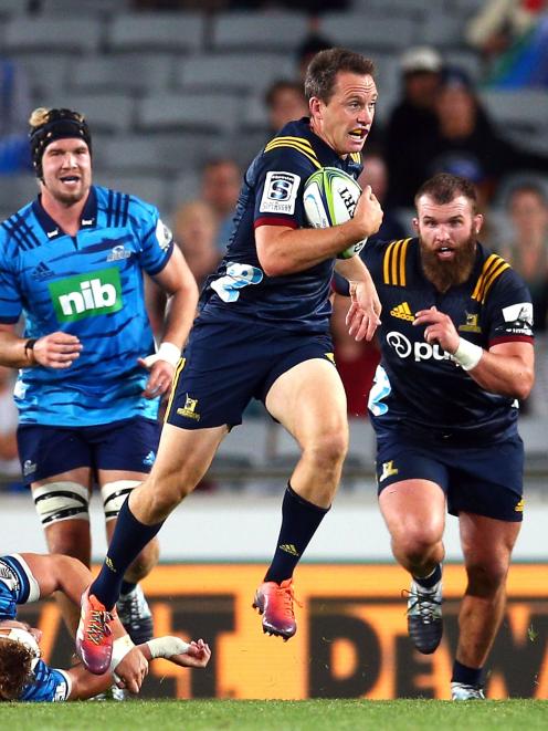 Highlanders co-captain Ben Smith looks to tear up the field as hooker Liam Coltman (right) comes...