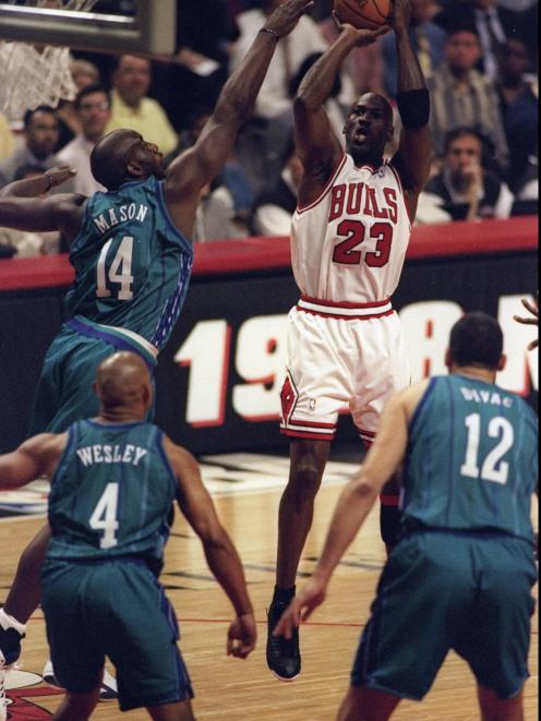 Chicago Bulls guard Michael Jordan shoots a mid-range jump shot against the Charlotte Hornets as...