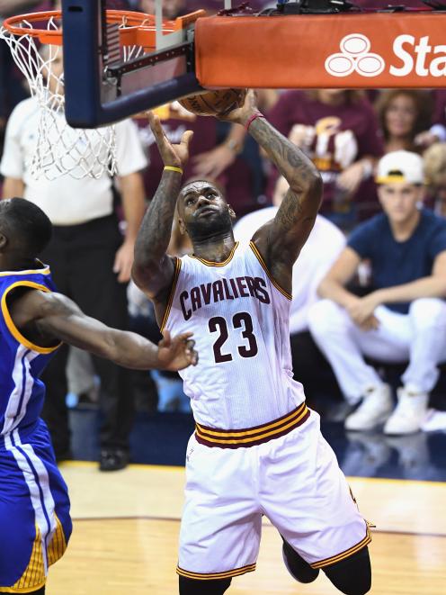 LeBron James takes the ball to the rim for the Cleveland Cavaliers during 
...