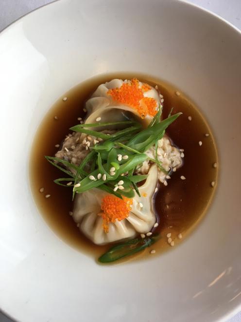 Prawn and pork dumplings are served in a chicken broth with eggplant puree, green bean and sesame...