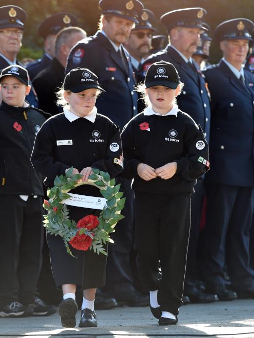 Ashley White (8),left and Sophia Thomson (7) of St Johns Mosgiel during the Mosgiel Anzac Day...