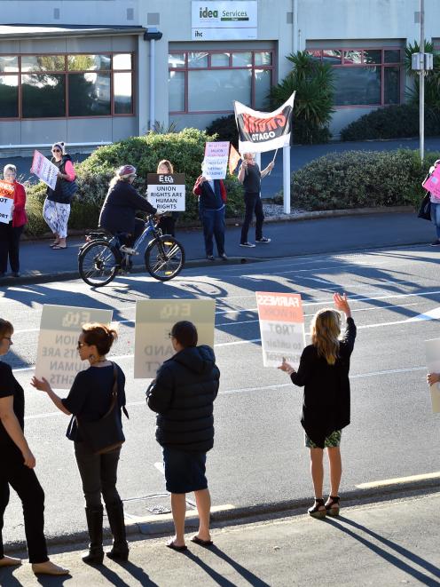 Idea Services staff picket outside the Dunedin office yesterday. PHOTOS: PETER MCINTOSH
