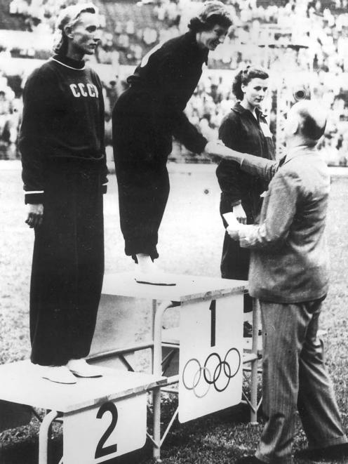 Yvette receives the Olympic long jump gold medal from New Zealands Sir Arthur PorrettYvette receives the Olympic long jump gold medal from New Zealand's Sir Arthur Porritt. 
