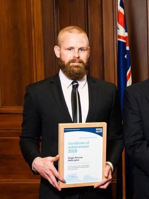 Otago Regional Rescue Helicopter flight paramedic Craig Didham holds his award for saving an...