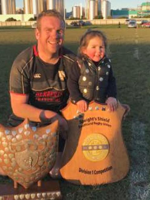 Karl Laurence and daughter Poppy (3) with some trophies won by the Edendale club last year. PHOTO...