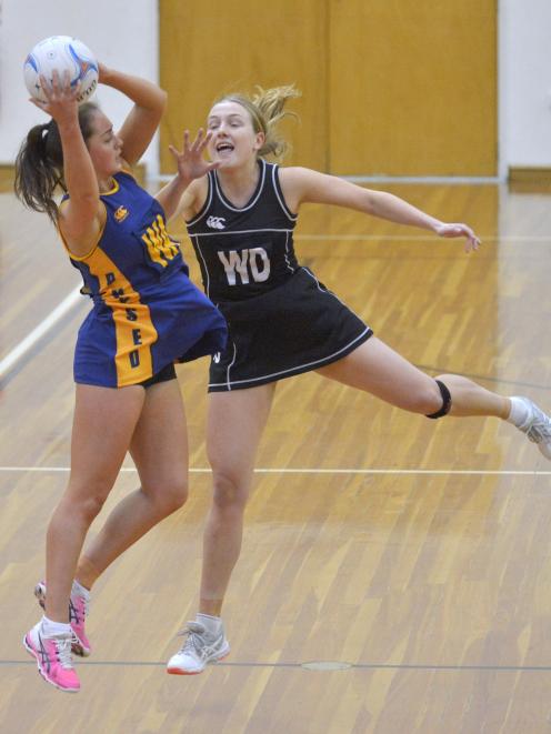 Physed wing attack Emily Henderson takes in a pass ahead of Southern Magpies wing defence Lauren...