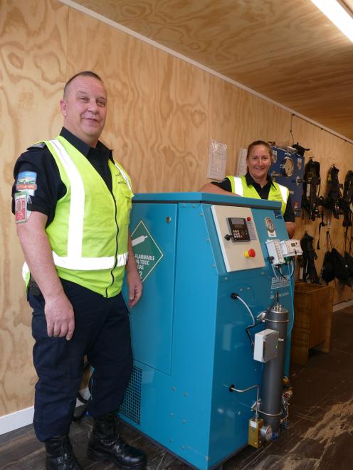 Queenstown Airport Rescue fire crew chief Royden Cullimore and firefighter Kylie Litchfield with the new compressor. Photo: Miranda Cook