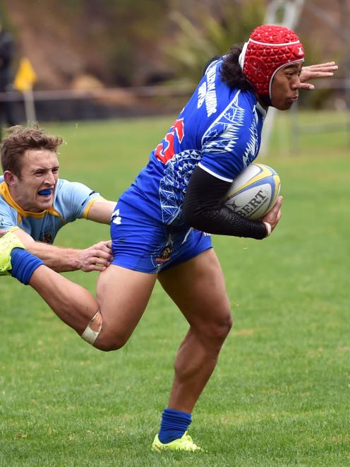 Harbour fullback Sala Halaleva gets past University first five-eighth Mike Williams during a...