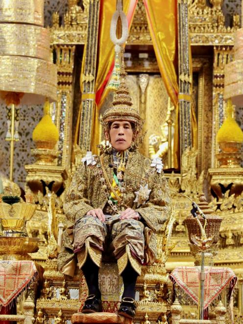 Thailand's King Maha Vajiralongkorn sits on the throne during his coronation inside the Grand Palace in Bangkok. Photo: Committee on Public Relations of the Coronation of King Rama X/Handout via Reuters