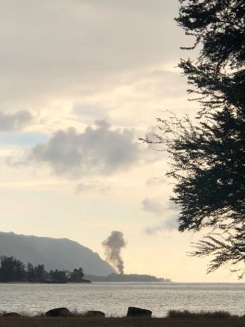 A plume of smoke rises after the crash in Haleiwa, Hawaii. Photo: LuckyWeLive.com via REUTERS 