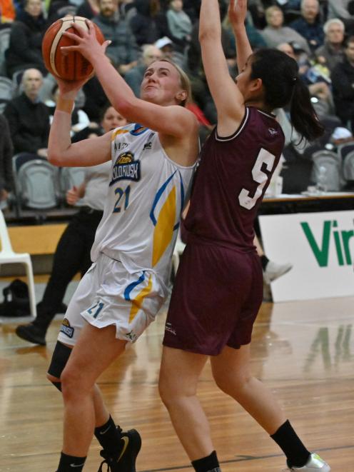 Otago Gold Rush guard Nicole Ruske takes the ball to the hoop pressured by Harbour Breeze guard...