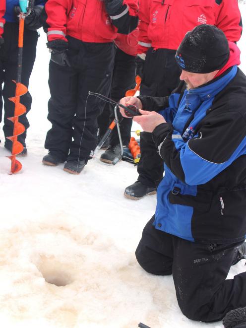 Marrku shows ice-fishing novices how it’s done.