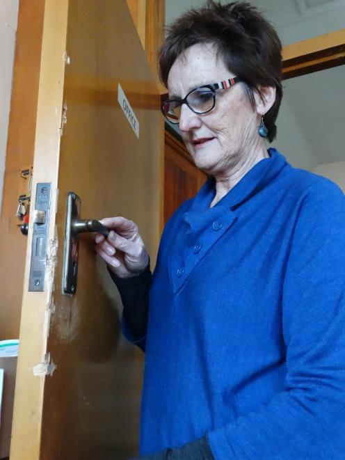 The Rev Rose Luxford inspects damage to a door at St Paul's Church in Coquet St in Oamaru. The...