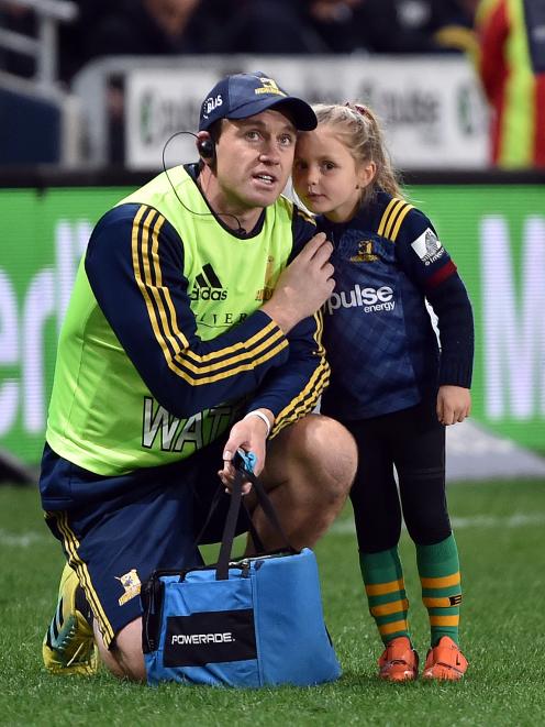 Highlander Ben Smith and his daughter, Annabelle, wait for the kicking tee to be brought out  at...