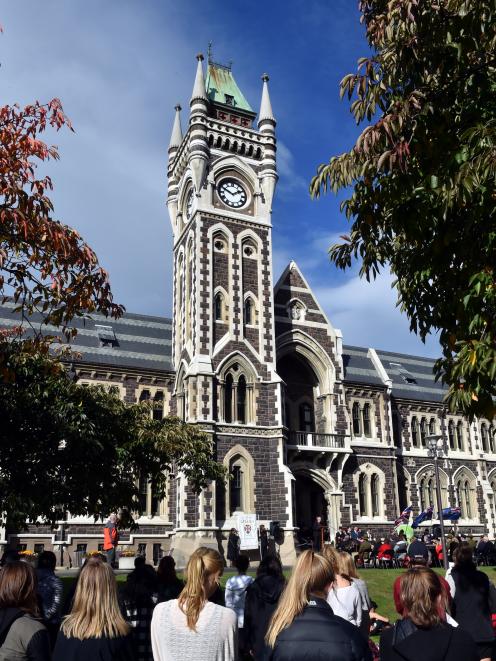 People gather on the University of Otago clocktower lawn for the OUSA Anzac Service in Dunedin....