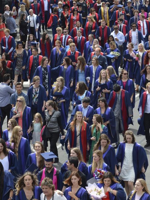 Otago Polytechnic graduands make their way up Moray Place before their graduation ceremonies....