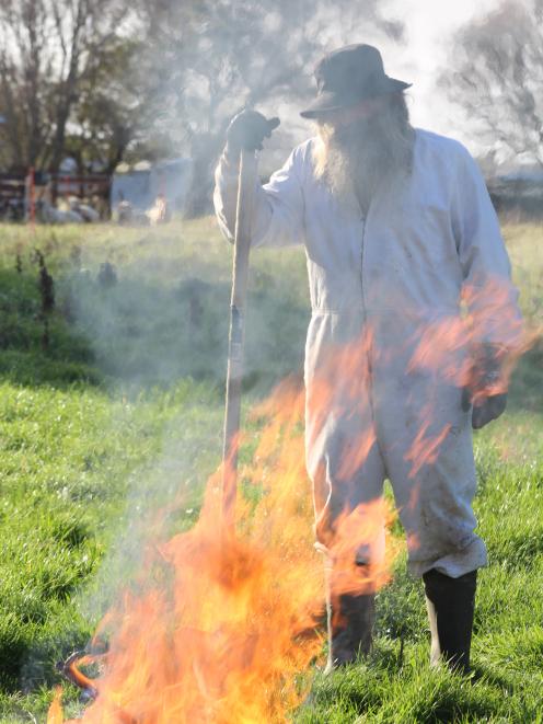 Southland commercial beekeeper Geoff Scott demonstrates what to do with an American foulbrood-infected hive - burn it. 