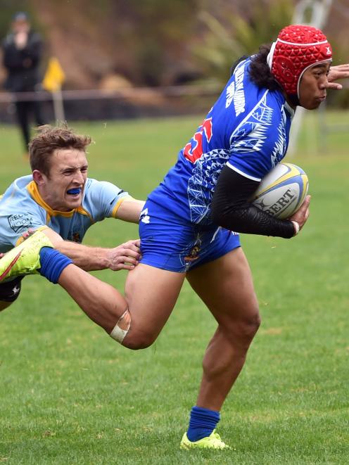 Harbour fullback Lisala Halaleva is tackled by University first five-eighth Mike Williams at...