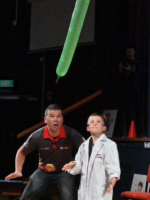 Junior scientist Leo Douglas (8), of Taieri Mouth, helps Steven Liddell demonstrate the laws of...