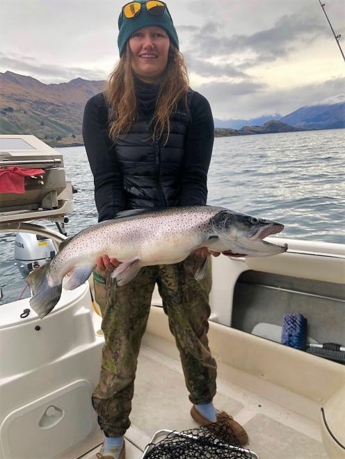 Emma McIntosh, of Wanaka, clutches a 12kg trout she fished out of Lake Wanaka. PHOTO: JENO...