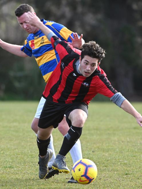 OMA United’s Raghdan Karim and Constable Aaron Burgess of the Blue n’ Gold Bobbies fight for the...